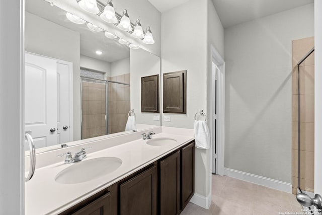 bathroom featuring tile patterned flooring, vanity, and walk in shower