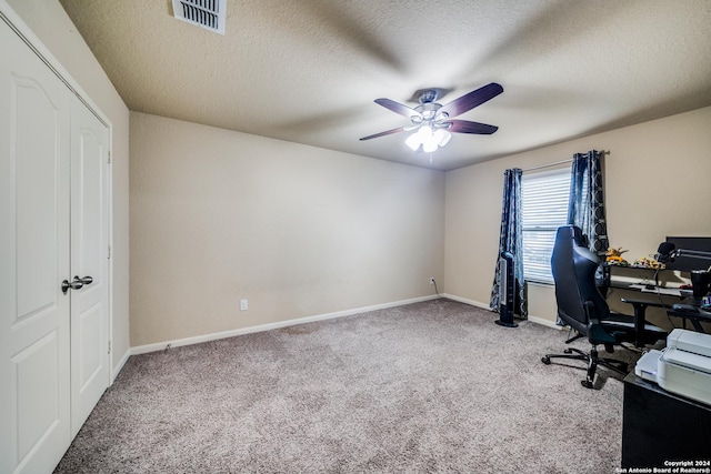 office space with carpet, a textured ceiling, and ceiling fan