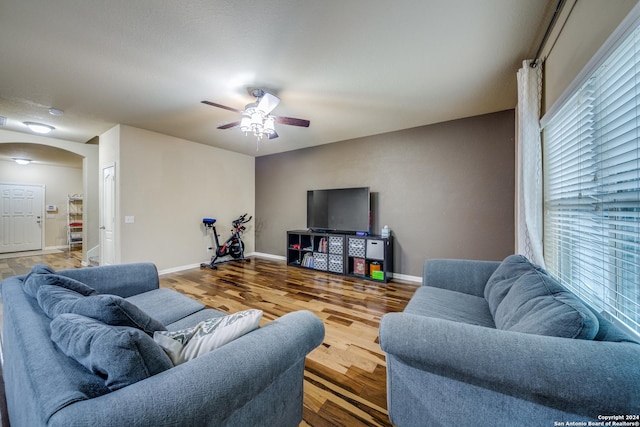 living room featuring hardwood / wood-style floors and ceiling fan