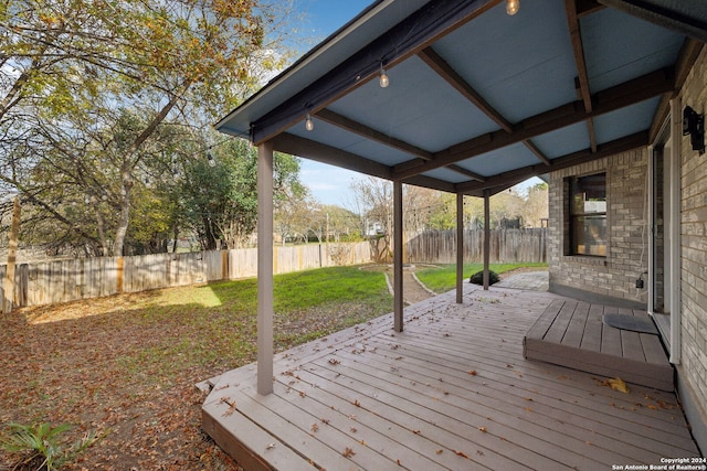 wooden terrace featuring a lawn