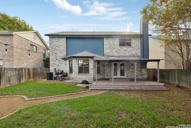 back of property featuring cooling unit, a lawn, a patio area, and french doors