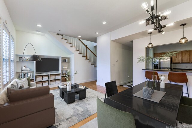 living room featuring an inviting chandelier and light hardwood / wood-style flooring