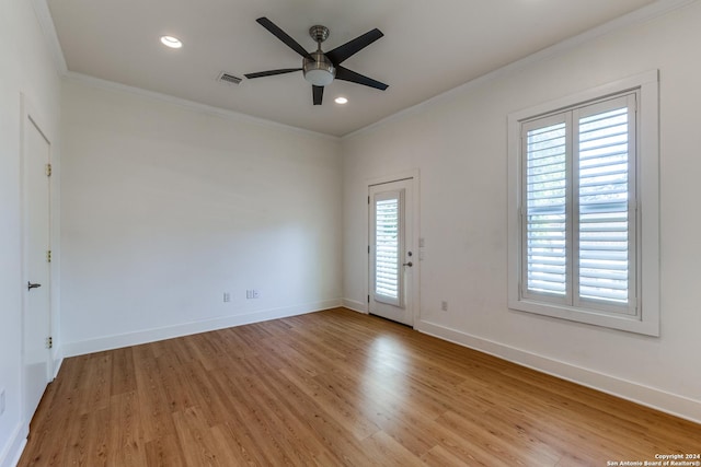 spare room with crown molding, plenty of natural light, ceiling fan, and light hardwood / wood-style flooring