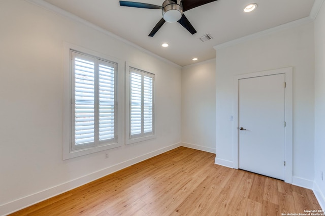 spare room featuring ceiling fan, light hardwood / wood-style floors, and crown molding