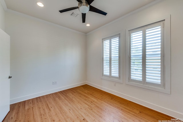 empty room with ceiling fan, crown molding, and light hardwood / wood-style flooring