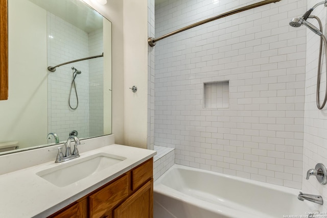 full bathroom featuring toilet, vanity, and tiled shower / bath combo