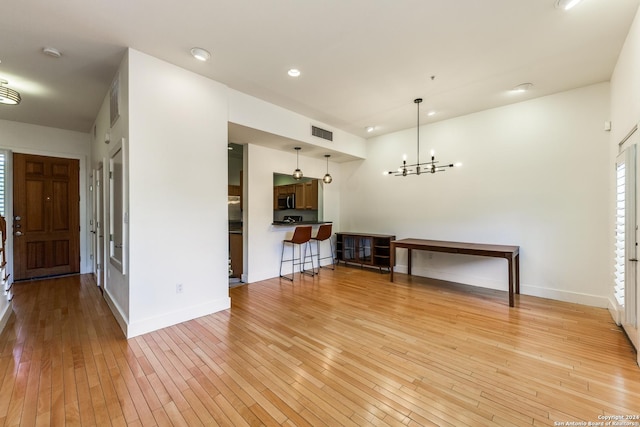 interior space featuring a chandelier and light wood-type flooring