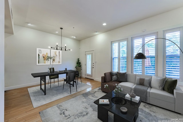 living room with a notable chandelier and light wood-type flooring