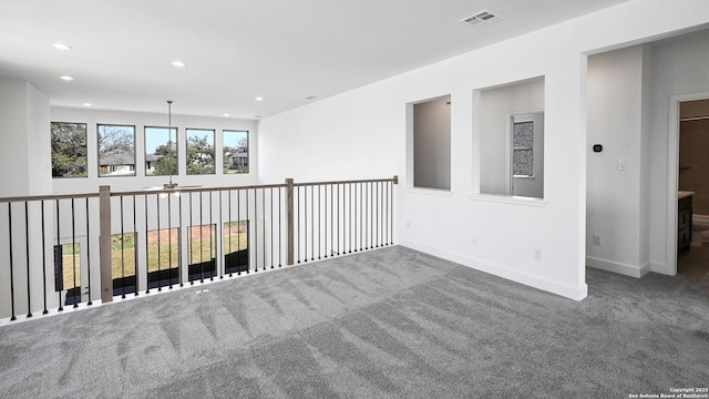 carpeted empty room featuring recessed lighting, visible vents, and baseboards