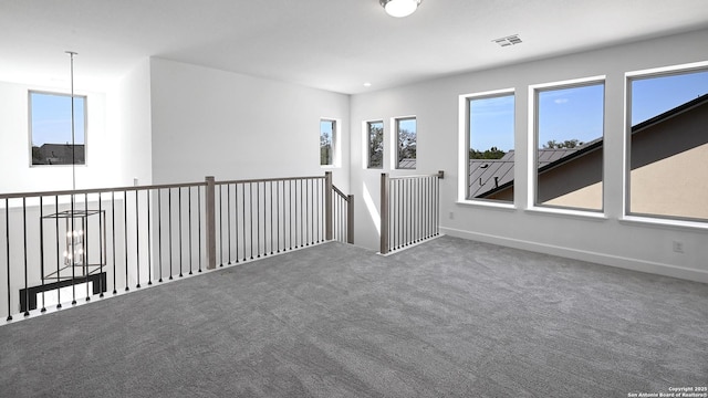 spare room with carpet floors, baseboards, visible vents, and recessed lighting