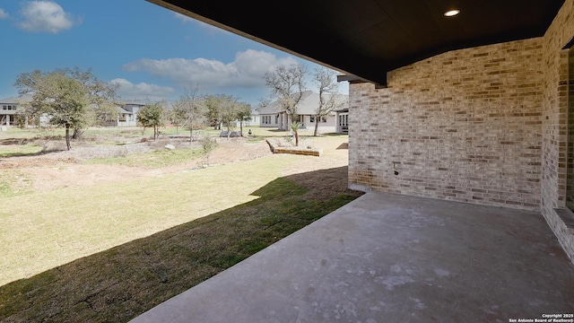 view of yard with a residential view and a patio