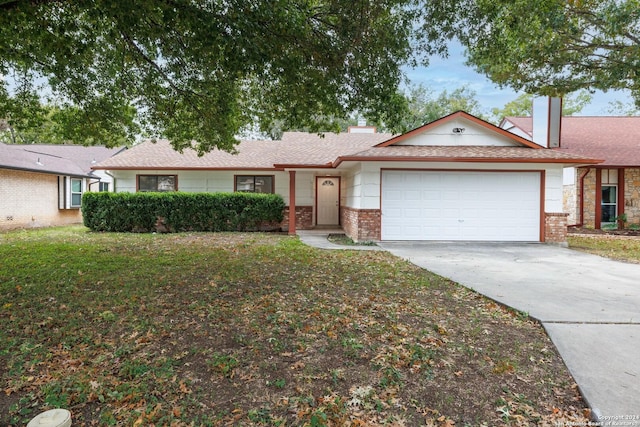 ranch-style house featuring a garage and a front yard