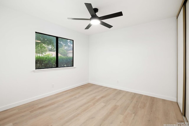 spare room featuring light wood-type flooring and ceiling fan