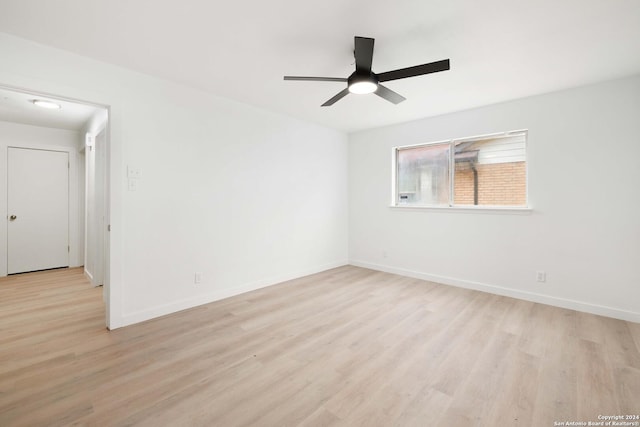 empty room featuring ceiling fan and light hardwood / wood-style flooring