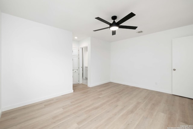 empty room with light wood-type flooring and ceiling fan