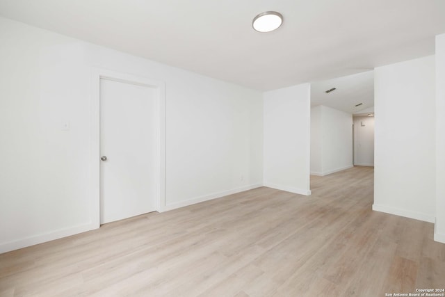 empty room with light hardwood / wood-style flooring