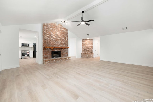 unfurnished living room featuring lofted ceiling with beams, light hardwood / wood-style floors, ceiling fan, and a brick fireplace