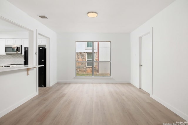 unfurnished living room featuring light hardwood / wood-style flooring