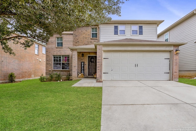 view of front of home with a front yard and a garage