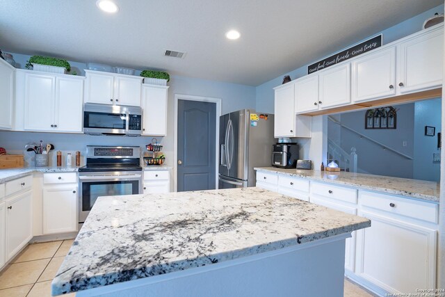 kitchen with a center island, white cabinets, and appliances with stainless steel finishes