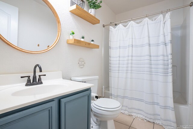 full bathroom with tile patterned flooring, vanity, toilet, and shower / bath combo with shower curtain