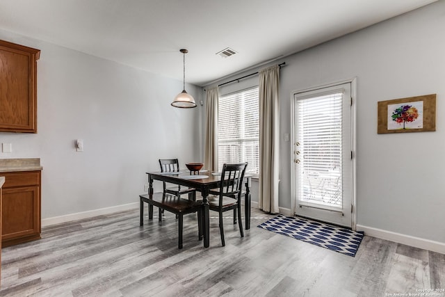 dining area featuring a healthy amount of sunlight and light hardwood / wood-style floors