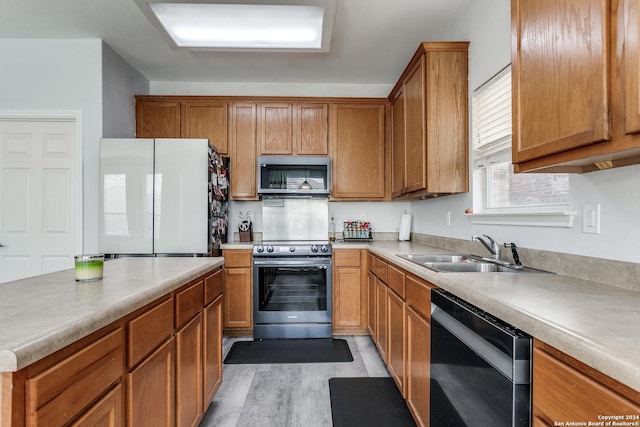 kitchen featuring sink, light wood-type flooring, and stainless steel appliances