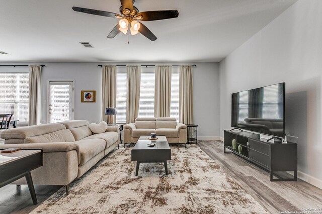 living room with hardwood / wood-style flooring and ceiling fan