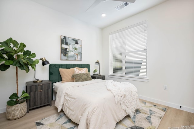 bedroom with light hardwood / wood-style flooring and ceiling fan