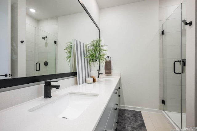 bathroom featuring tile patterned floors, vanity, and walk in shower