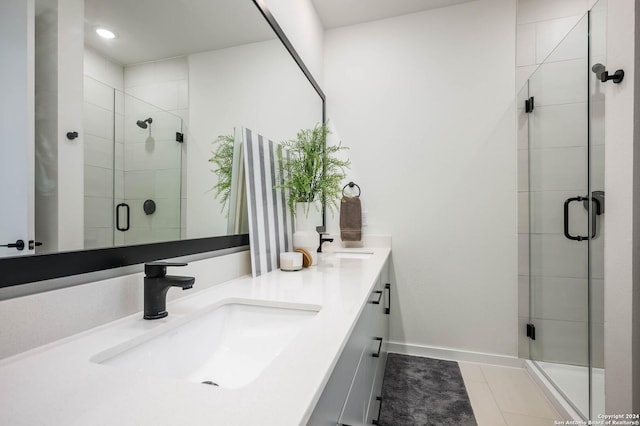 719 E Locust St Unit 2103, San Antonio, TX 78212 - bathroom featuring double vanity, a shower stall, tile patterned flooring, and baseboards