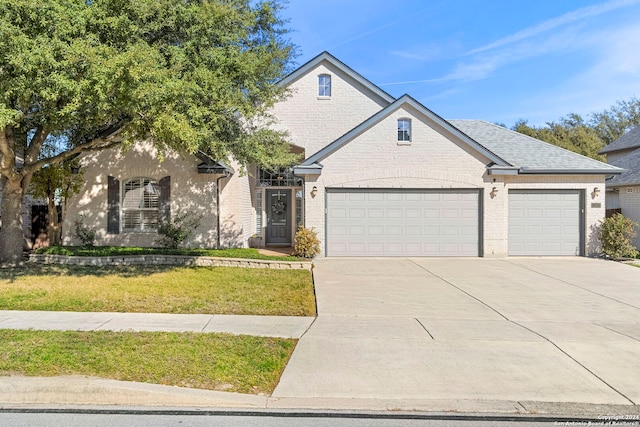 view of front facade with a garage and a front lawn