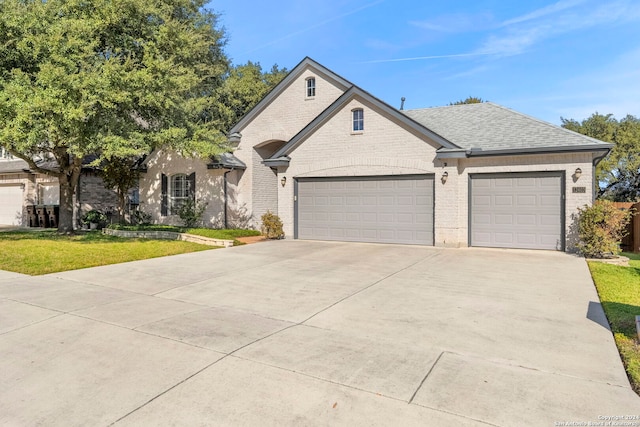 view of front of house featuring a garage and a front yard