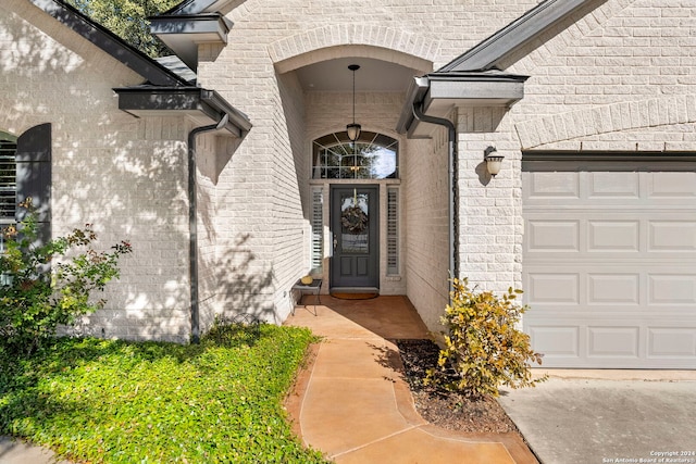 doorway to property with a garage