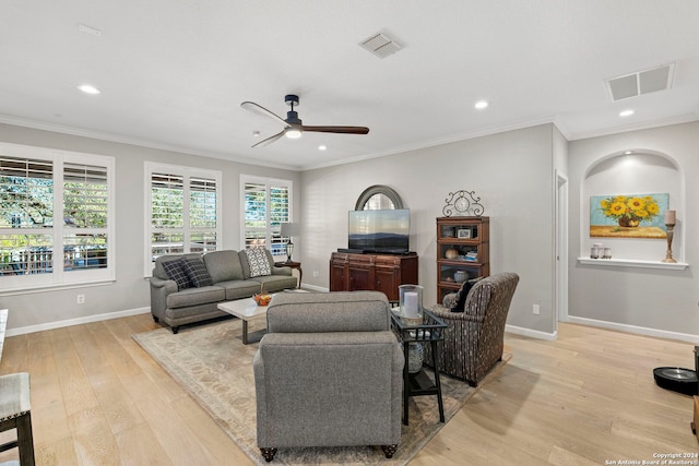 living room with ceiling fan, ornamental molding, and light hardwood / wood-style flooring