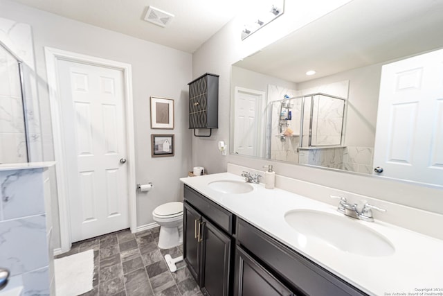 bathroom featuring vanity, toilet, and walk in shower