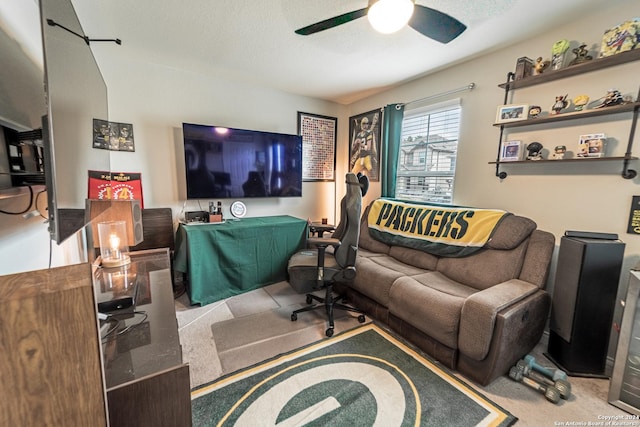 interior space with a textured ceiling, ceiling fan, and light carpet