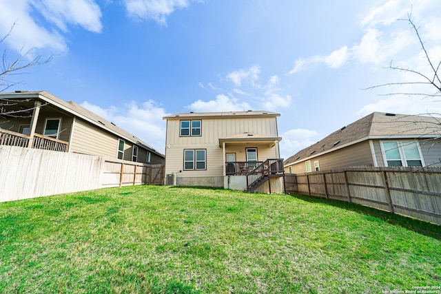 back of property with a lawn