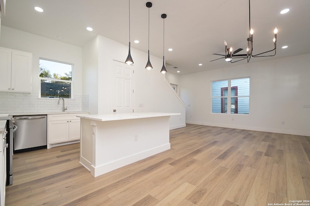 kitchen featuring dishwasher, light hardwood / wood-style flooring, white cabinetry, and a kitchen island