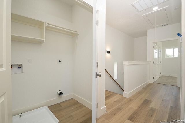 clothes washing area featuring hookup for an electric dryer, hookup for a washing machine, and light hardwood / wood-style flooring