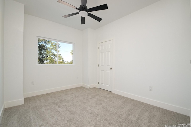 empty room featuring light carpet and ceiling fan