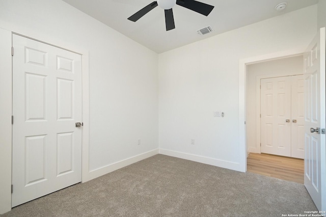 carpeted empty room with ceiling fan