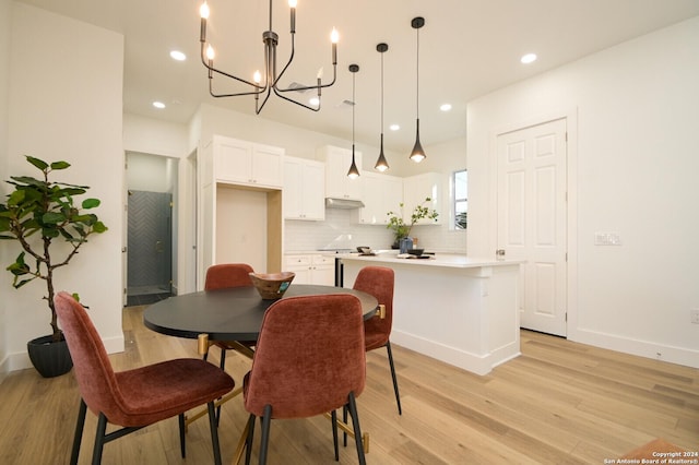 dining space with a chandelier and light wood-type flooring