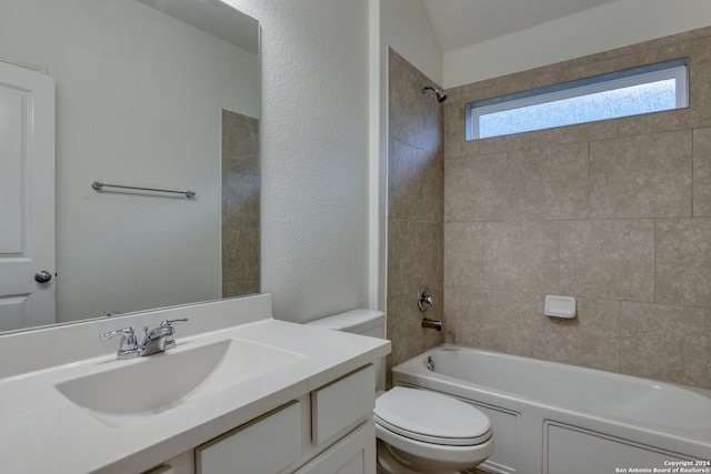 full bathroom with vanity, tiled shower / bath combo, and toilet