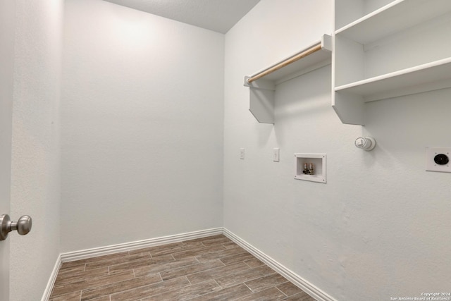 laundry room featuring hookup for a washing machine, electric dryer hookup, and dark wood-type flooring