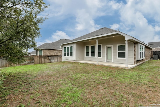 back of house with a lawn, cooling unit, and a patio area