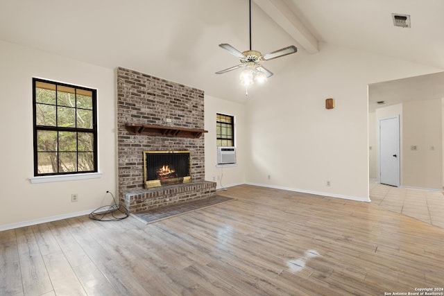 unfurnished living room featuring lofted ceiling with beams, cooling unit, ceiling fan, a fireplace, and light hardwood / wood-style floors