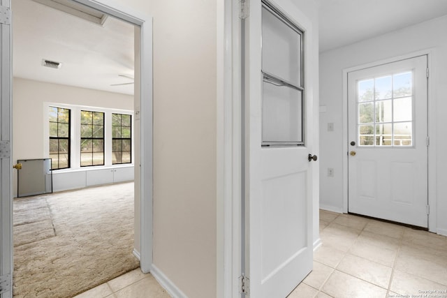 hall featuring light carpet and a wealth of natural light