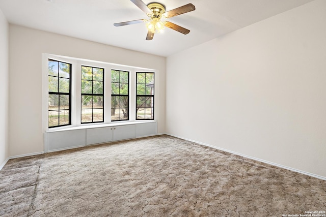 spare room with carpet flooring and ceiling fan