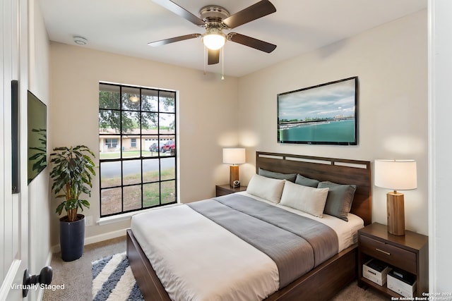 bedroom featuring carpet flooring, multiple windows, and ceiling fan